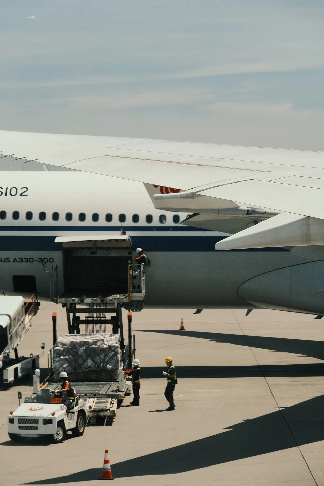 An aircraft being loaded with cargo at an airport