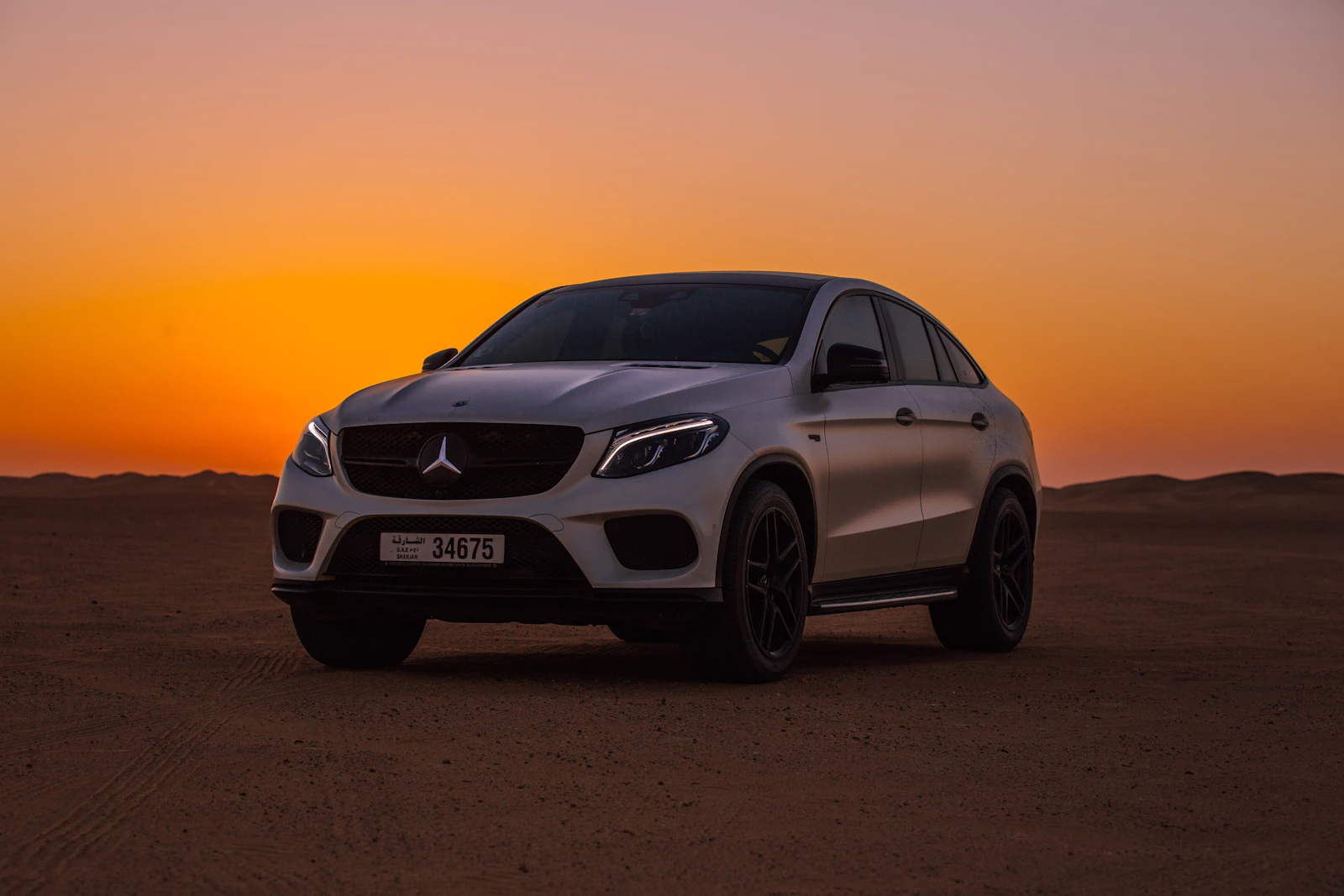 White Mercedes-Benz SUV photographed at sunset
